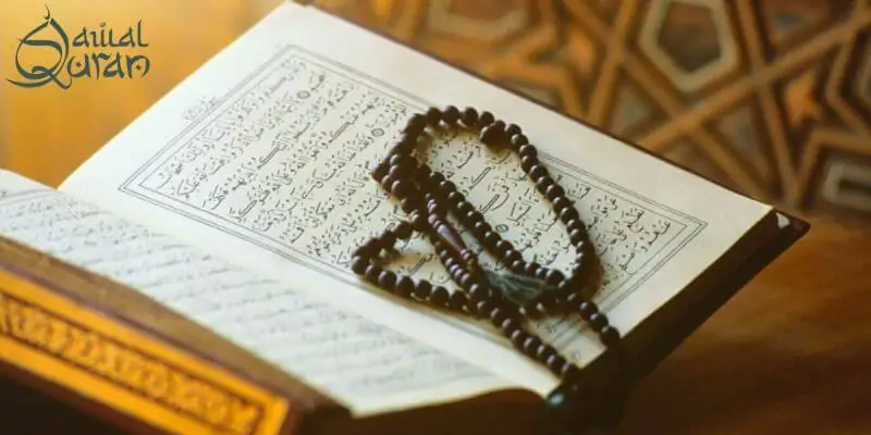An open Quran book with Arabic text.