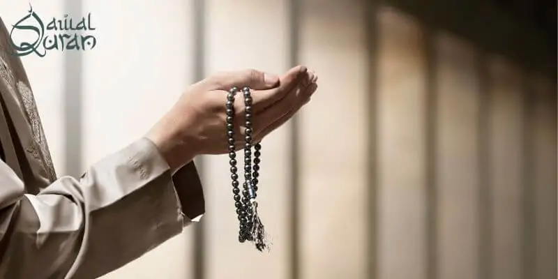 A man holding hands and saying dua.